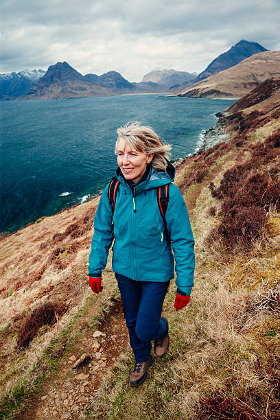 istock Female hiker walking along coastal trail in Skye 517991796