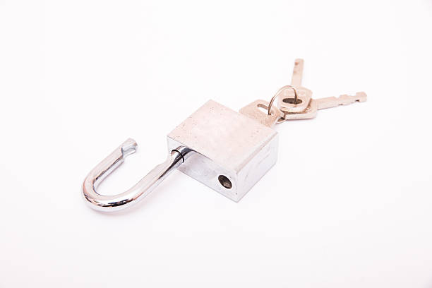 istock Metallic padlock with three keys in keyhole isolated on white 517992828