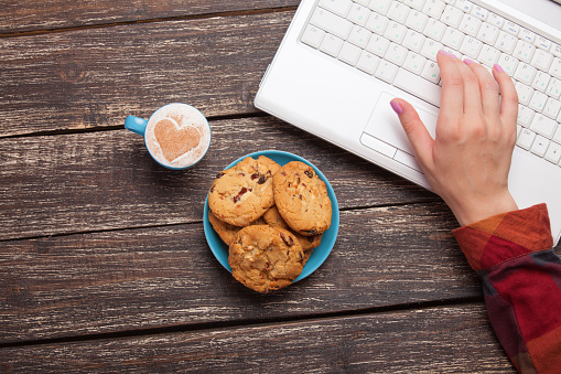 Cookie and women hand with notebook.