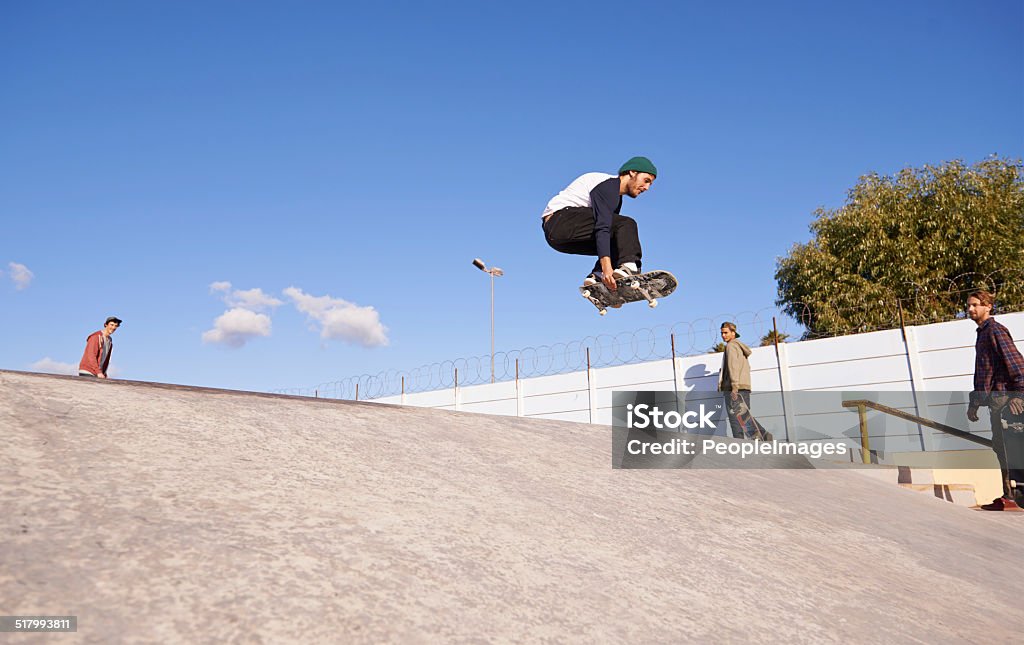 Getting some serious air A young man doing tricks on his skateboard at the skate park Activity Stock Photo
