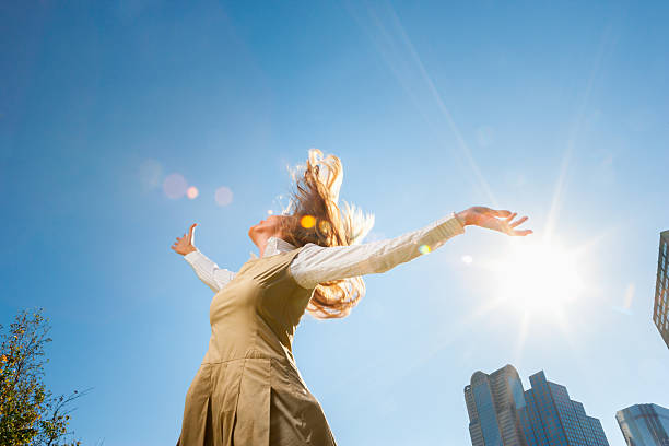 Girl spinning outside in sunshine