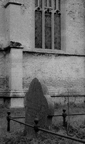 istock Ghostly image of an old grave in front of a chapel 517994568