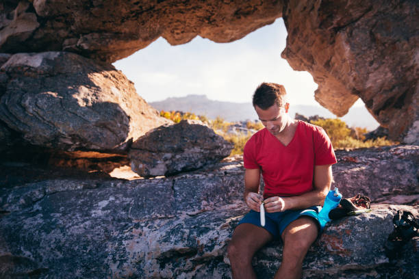 istock Man resting from outdoor activity and eating energy bar 517994836