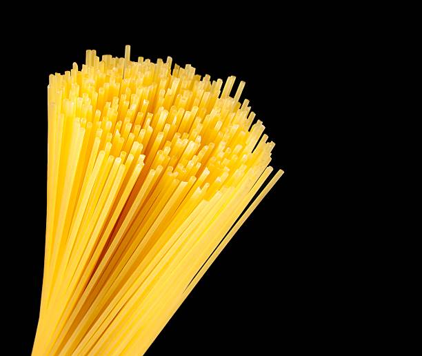 istock raw pasta spaghetti on black background with space for text 517995022