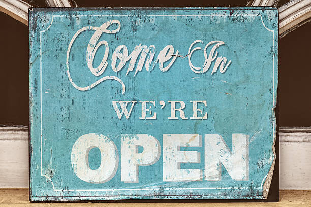 istock Weathered come in we're open sign 517995028