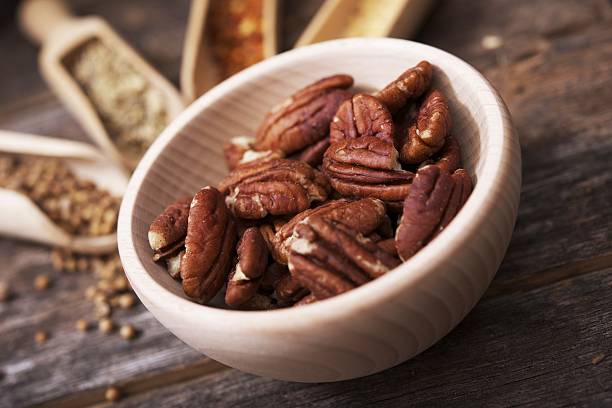 istock Pecans in the Wooden Bowl 517995029