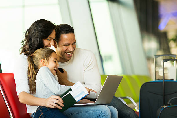 istock family using laptop computer at airport 517995285