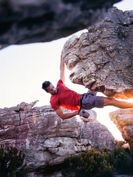 istock Rock climber with hand in chalk bag hanging on boulder 517995418