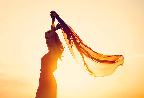 istock Women with fabric on sunset. 517995839