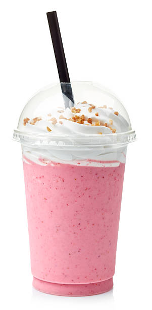 Strawberry milkshake Strawberry milkshake covered with whipped cream in plastic glass isolated on white background milkshake stock pictures, royalty-free photos & images
