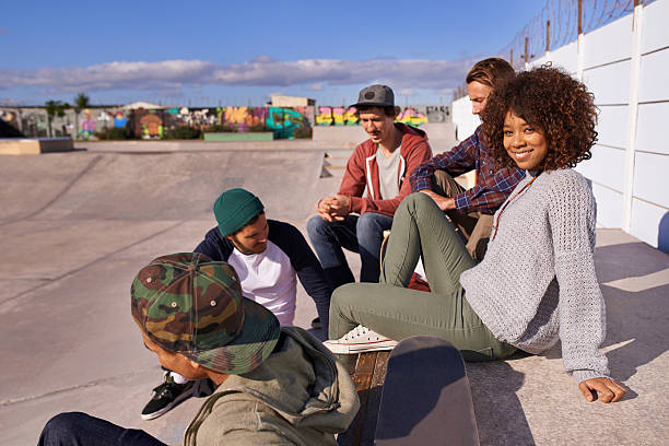 Socializing at the skatepark Shot of a group of friends socializing at the skatepark x games stock pictures, royalty-free photos & images