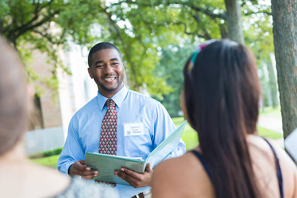 istock Friendly college tour guide talking to prospective students 517996109