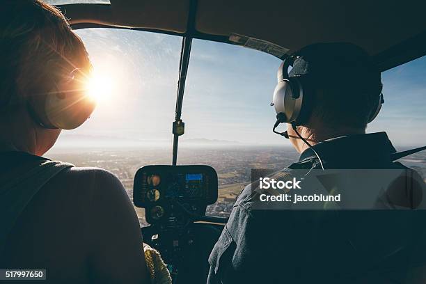 Two Pilots In A Helicopter Flying On A Sunny Day Stock Photo - Download Image Now - Helicopter, Inside Of, Piloting