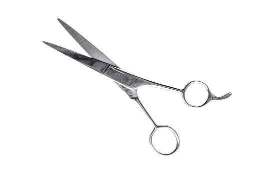 Hairdresser or barber silver professional scissors for cutting hair. Isolated on white background