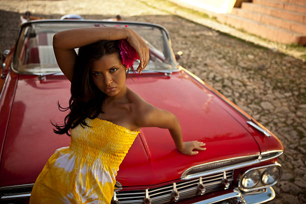 istock Beautiful woman posing with a red car 517998019