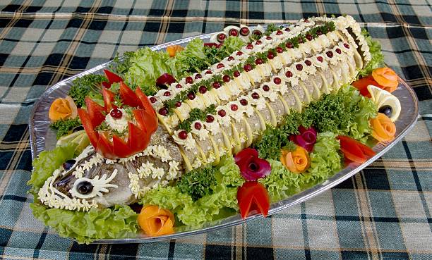 Dish with fish fillet with vegetables, mayonnaise, parsley, lettuce