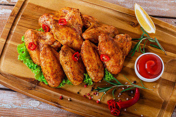istock fried chicken wings with red sauce 517998753
