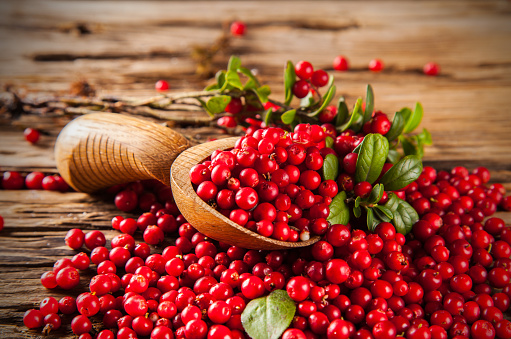 Cranberries on wooden table, background