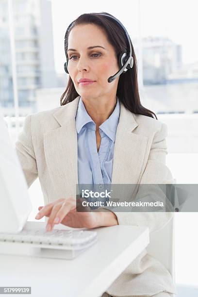 Businesswoman Taking A Phone Call Stock Photo - Download Image Now - Call Center, Real Estate Agent, Serious