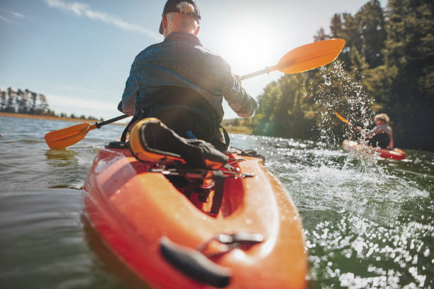 istock Man in kayak paddling on lake 517999180