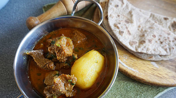 istock Home cooked meat and potato curry with roti 517999186