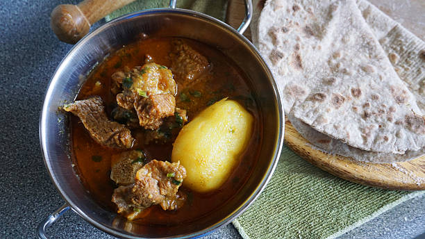 istock Home cooked meat and potato curry with roti 517999368