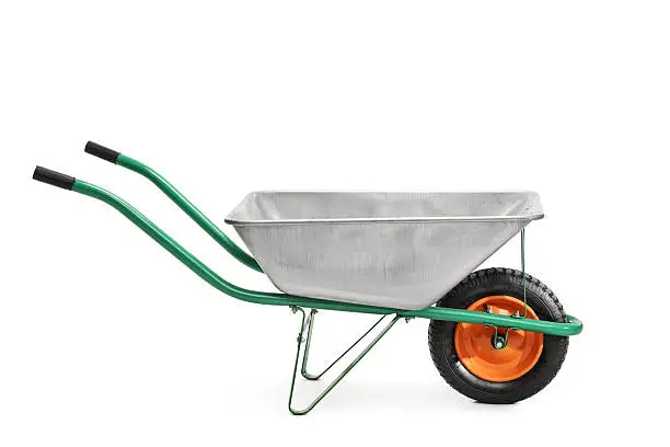 Studio shot of a metal wheelbarrow with green handles isolated on white background