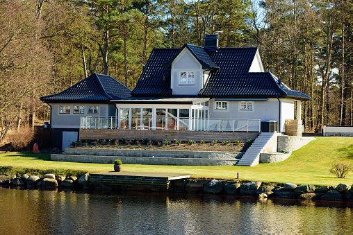 Ahus, Sweden - March 20, 2016: Well situated villa with very neat garden. The green grass is finely trimmed. A seaside residence with its own pier.