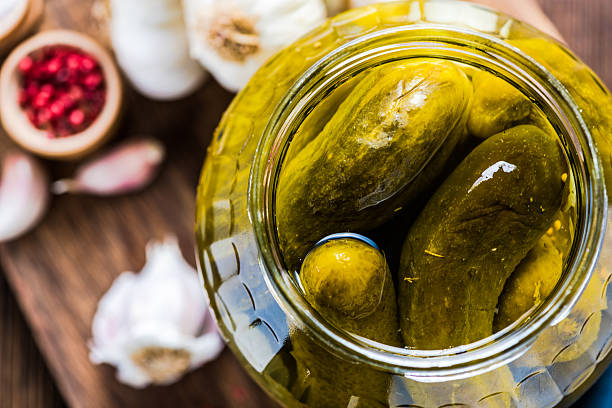 Pickled gherkins in jar, fermented food Pickled gherkins in jar, fermented food with spices pickled stock pictures, royalty-free photos & images