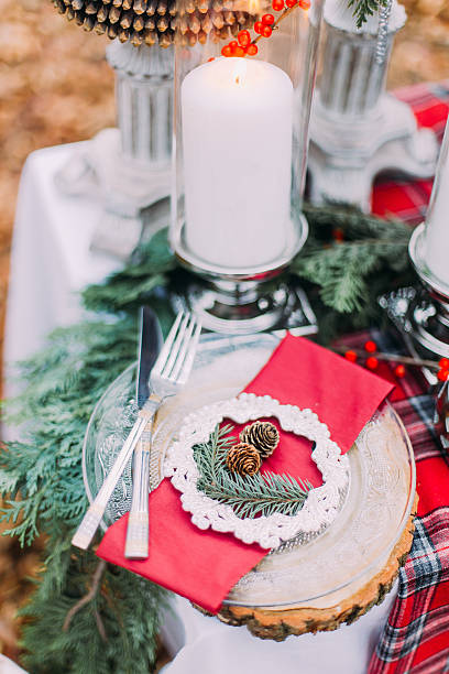 istock Beautiful decorated christmas table with candles and pines close up 518002528