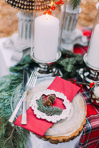 istock Beautiful decorated christmas table with candles and pines close up 518002568