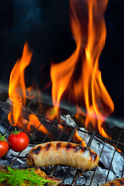 istock Grilling sausages on barbecue grill 518003238