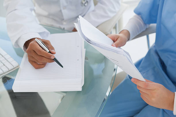 istock Doctor and surgeon reviewing notes 518012357