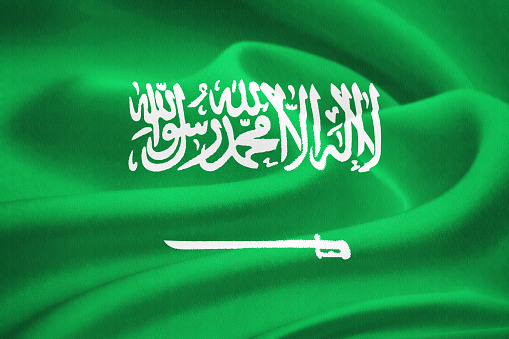 Flag of Saudi Arabia waving in the wind. Silk texture pattern