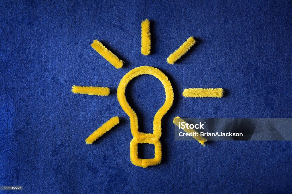 Idea Inspiration concept yellow pipe cleaner light bulb metaphor for good idea Pipe Cleaner Stock Photo