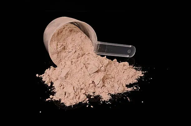 A scoop of chocolate whey isolate protein 