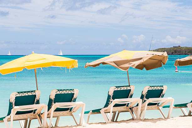 istock Sun Umbrellas Over Green Chairs on Beach 518016525