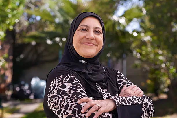 Portrait of a mature muslim woman standing outside