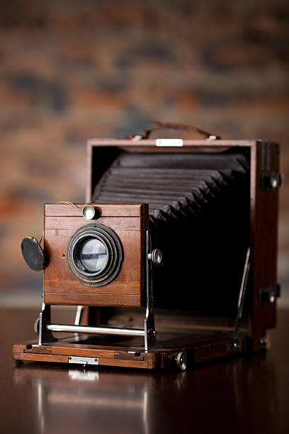 istock Antique Old photo Camera on wooden table 518017453