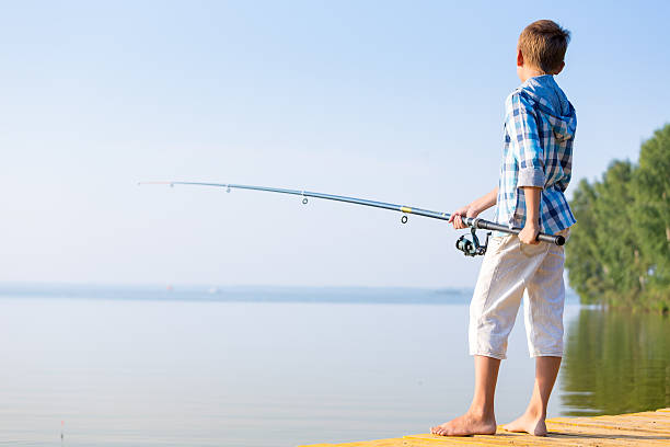 istock Young bou with fishing rod 518018509