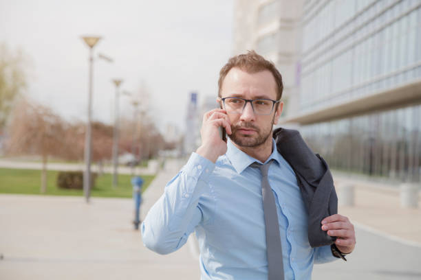 istock Manager talking on smart phone outdoors 518018962