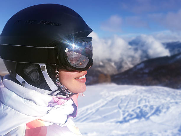 istock Young woman snowboarder in mountains 518019340