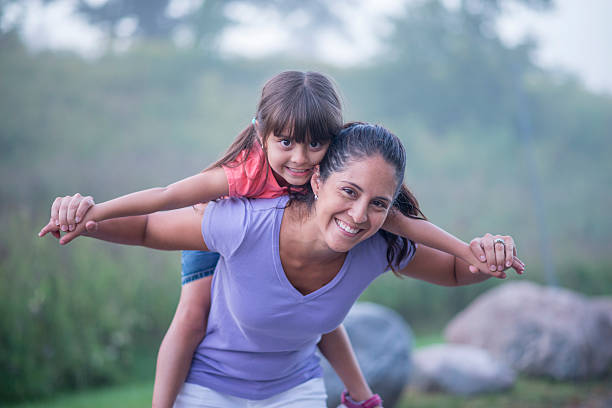 istock Little Girl Getting a Piggy Back Ride 518019724