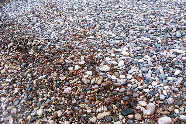 istock Pebble stones on coastline blurred by transparent sea water 518020474