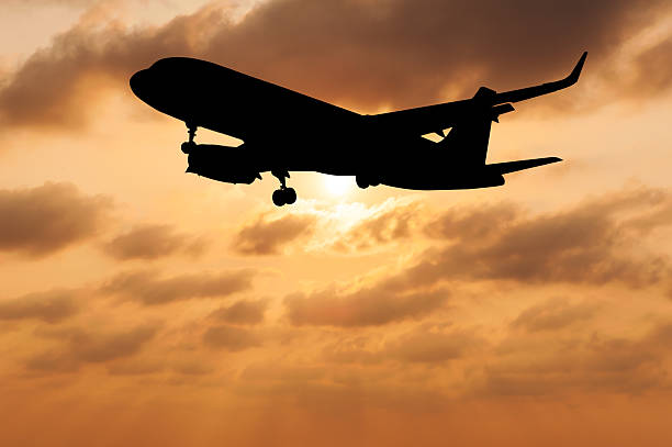istock Silhouette airplane on blurred sky sunset 518021078