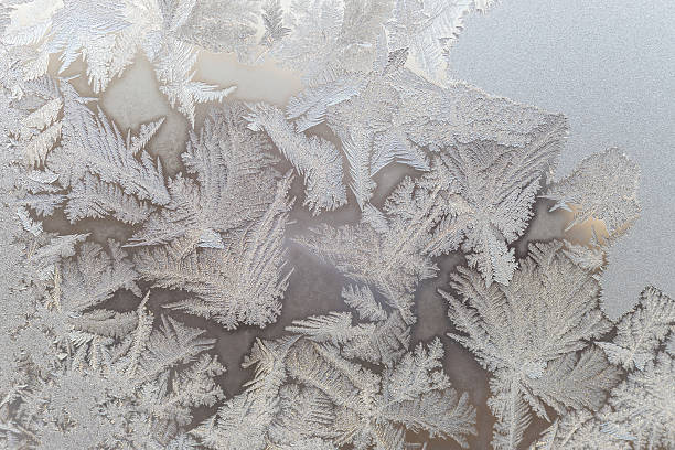 istock Ice floral pattern on glass in blurred vignette. Macro view. 518021926