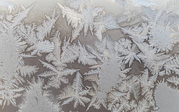 istock Ice floral pattern on glass in blurred vignette. Macro view. 518022002