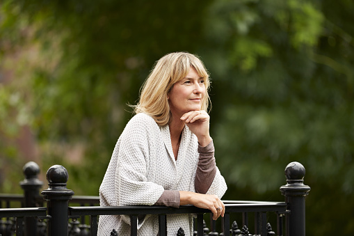 Upset aged woman standing outdoors, loneliness in retirement, problem