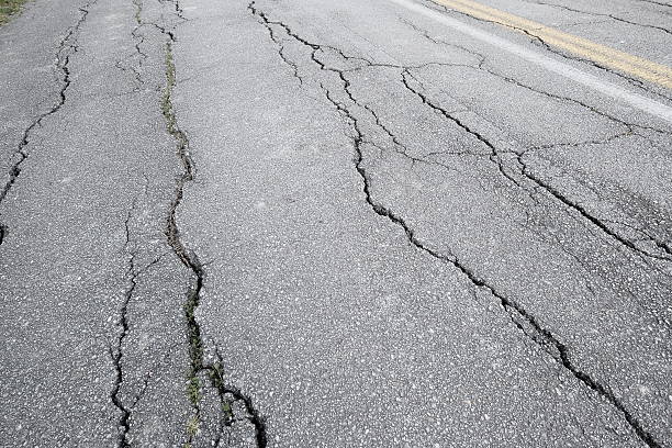 Weather and usage made the tarmac on this secondary road visibly cracked.