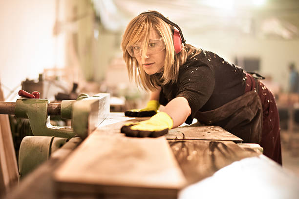 istock Blonde woman cutting planks 518023914